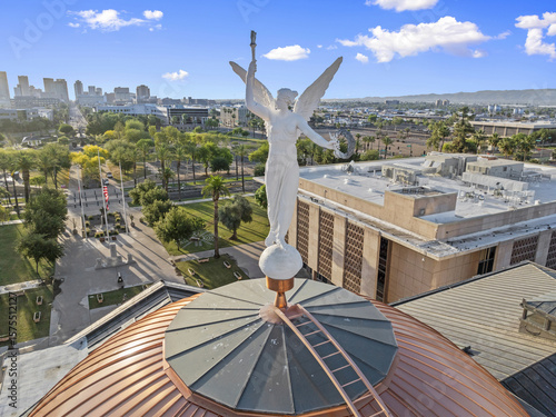 Aerial view of the copper-clad dome of the Arizona State Capitol crowned by Winged Victory gleams against the Phoenix skyline, Phoenix, Arizona, United States.