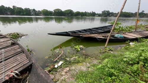 Wooden Boat Floating on Calm River in Natural Landscape