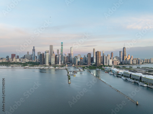 Wallpaper Mural Aerial view of the city skyline and Navy Pier stretching into the lake, a symphony of concrete and water under a pastel sky, Chicago, Illinois, United States. Torontodigital.ca