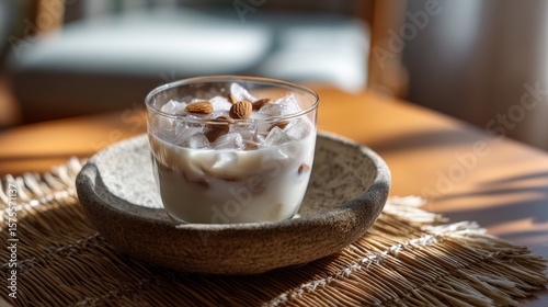 Creamy Almond Milk Drink with Ice in Glass Bowl on Wooden Table