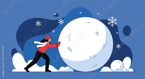 A young woman pushing a giant snowball on a snowy day