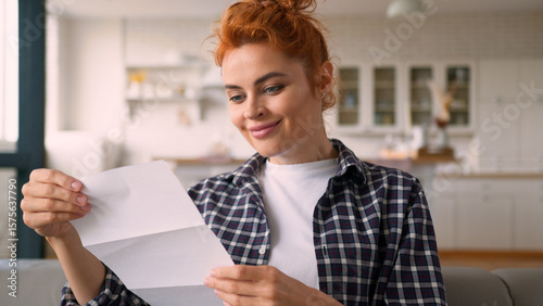 Quadro su tela Caucasian woman female girl lady check correspondence checking open envelope rea