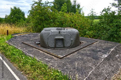 Old sherman tank turret embedded in concrete, repurposed as a fixed fortification in the netherlands, a relic of world war ii bridge defense