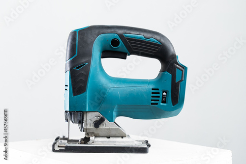 Isolated photo of a cordless jigsaw machine, on white background.