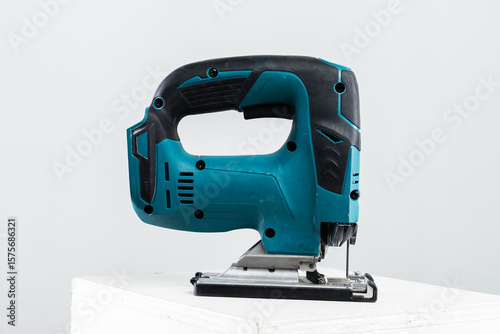 Isolated photo of a cordless jigsaw machine, on white background.