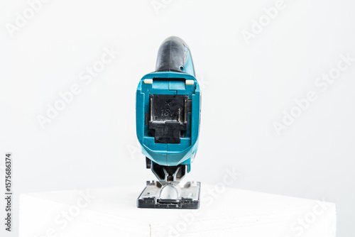 Isolated photo of a cordless jigsaw machine, on white background.