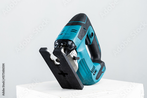 Isolated photo of a cordless jigsaw machine, on white background.