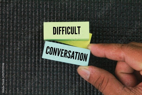 colored paper with the word DIFFICULT CONVERSATION. difficult conversation concepts. a dialogue that addresses sensitive, controversial, or emotionally charged topic