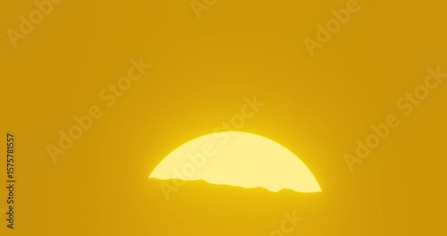 The sun rises slowly from behind the silhouette of the mountains.