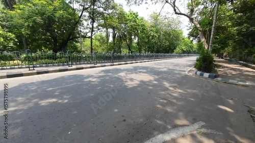 City Road with Moving Vehicles and Green Surroundings in Kolkata – 09.02.25