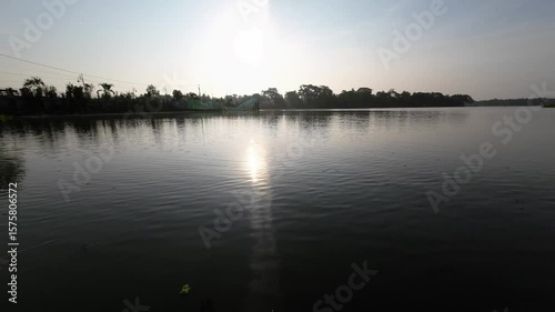 Tranquil Sunset Over a Serene Riverside Landscape