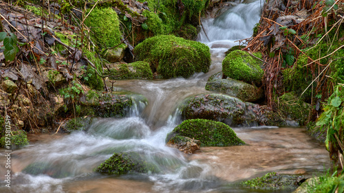 Majestic Allerheiligen Waterfalls: Serene Long Exposure Cascade in Black Forest National Park Germany. Scenic Forest Stream Flows Through Lush Greenery and Moss Covered Rocks Creating Ethereal