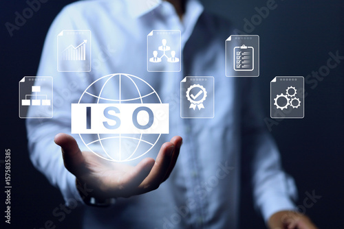 ISO concept in white tone with businessman holding standard globe represents the quality of business whether it is product or service