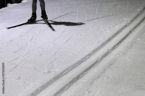 Cross-Country Skier in Action on Snowy Evening Outdoors