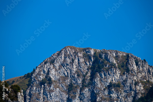Majestic Rocky Mountain Peak With a Clear Blue Sky Background