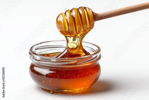 A mesmerizing close-up of golden liquid being drizzled from a wooden dipper into a clear glass jar, showcasing its rich texture and natural sweetness.

