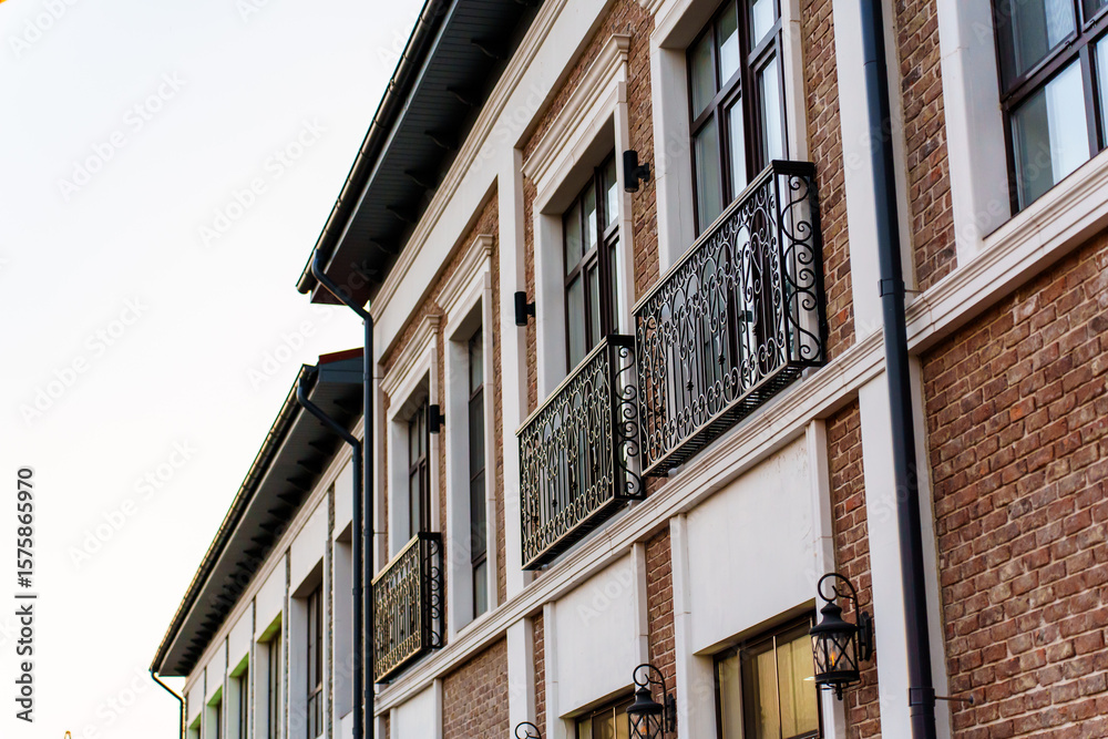 Naklejka premium A modern building in a classic style with French balconies.