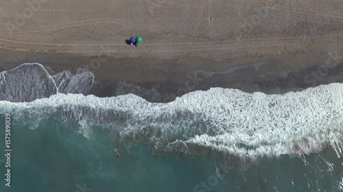 Fly with my drone along the beach path at the north of Crete during vacation summer time and a blue sky sunny day