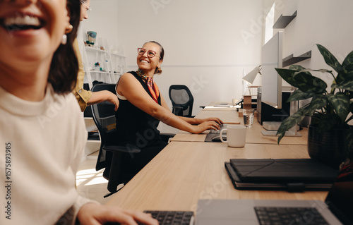 Colleagues sharing a cheerful moment in a professional office workspace