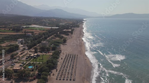 Fly with my drone along the beach path at the north of Crete during vacation summer time and a blue sky sunny day