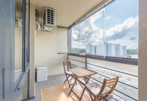 Cozy Urban Balcony with Wooden Furniture and Scenic City View