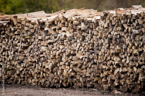 Dry oak wood ready for heating. Wooden logs stacked on top of each other. Stack of wood, firewood, background.