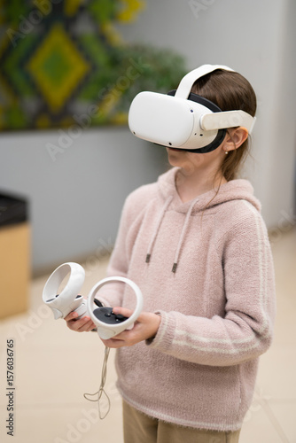 a child in virtual reality glasses plays a game