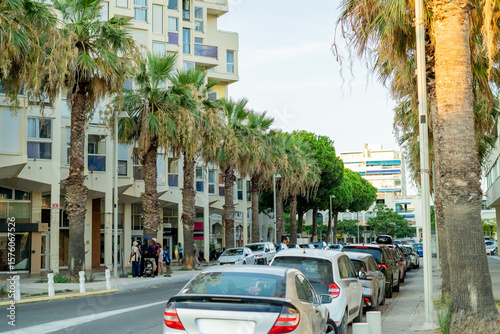 Fototapeta Naklejka Na Ścianę i Meble -  Streets of a small French town by the sea. White buildings, roads, palm trees. Europe.