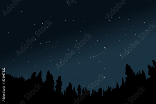 The night sky filled with stars including the Big Dipper and a bright green meteor above a skyline of dark evergreen trees. This was part of a meteor shower.