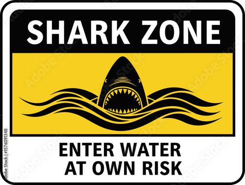 A warning sign depicting a shark emerging from water, reading "Shark Zone, Enter Water at Own Risk".