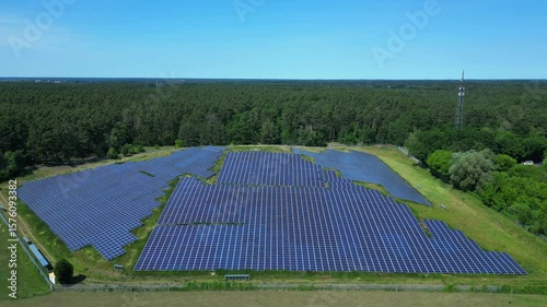 Wallpaper Mural Photovoltaic panels providing clean energy in a solar farm on hill near a forest in Germany. Best aerial view flight static tripod hovering drone Torontodigital.ca