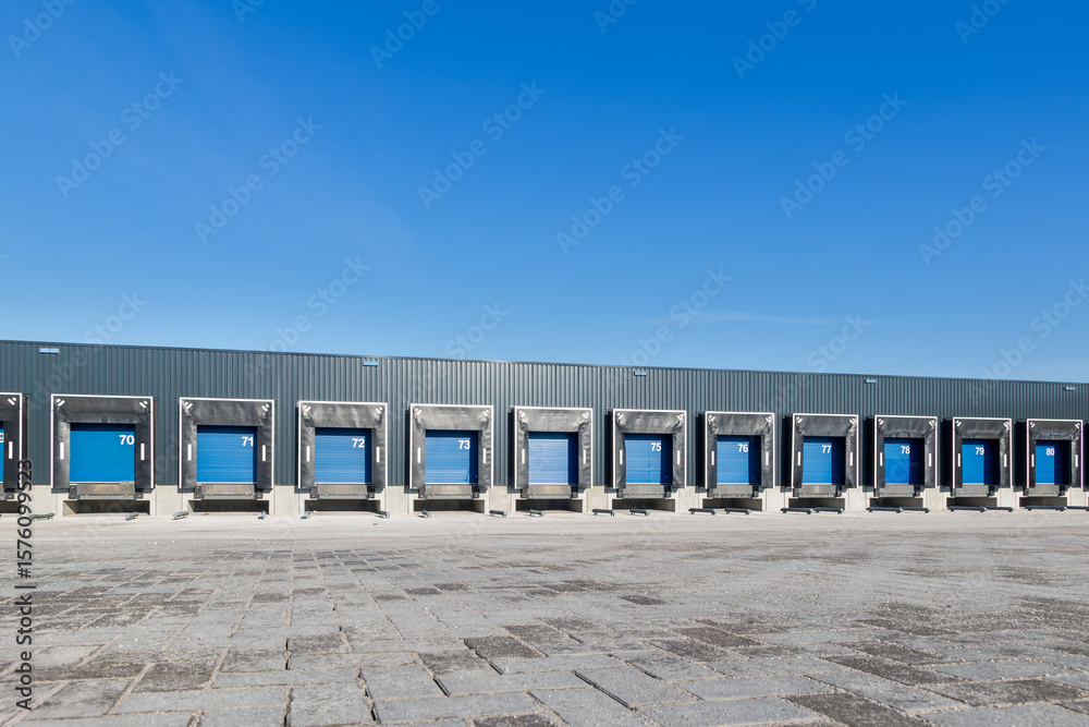 Obraz premium Modern industrial logistics warehouse row of closed loading docks with metal shutter doors for freight transport