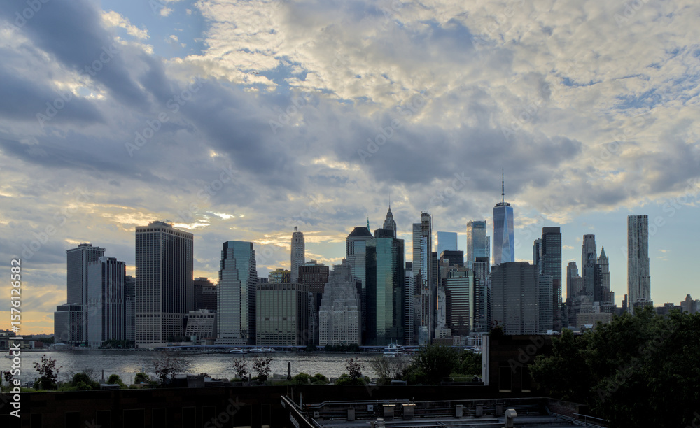 Fototapeta premium beautiful sky glow colorful sunset new york city skyline silhoutte manhattan skyscrapers clouds summer east river boats waterfront harbor travel tourism usa america