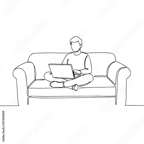 Remote worker sitting on couch and using laptop at home  