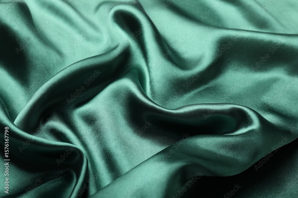 Obraz premium Crumpled green silk fabric as background, closeup
