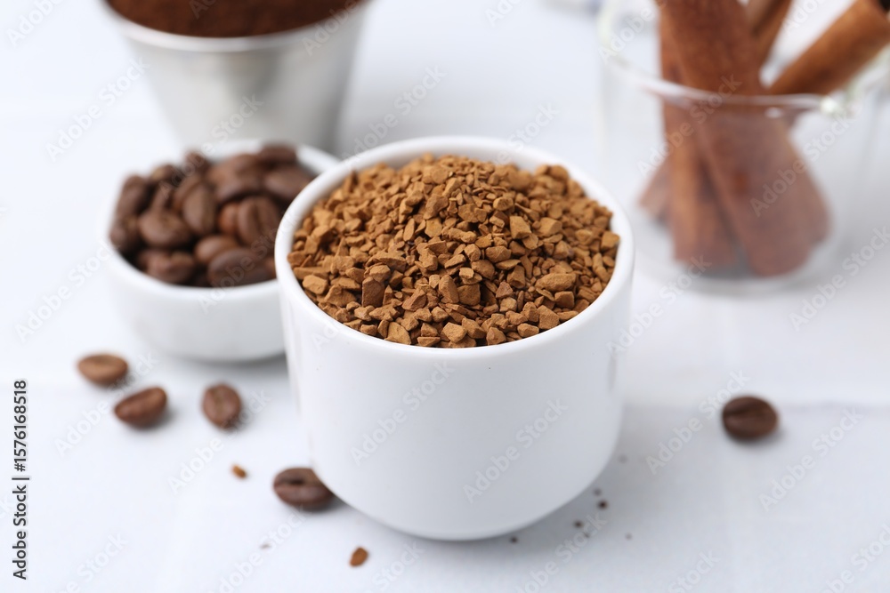 Granulated instant coffee and beans on light table, closeup Granulated instant coffee and beans on light table, closeup