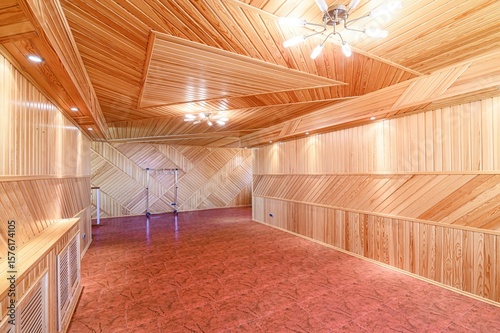 Fotografi spacious room clad in light wood panels with patterned walls