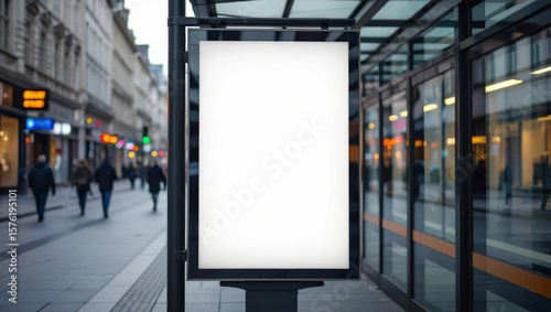 Fototapeta Naklejka Na Ścianę i Meble -  Blank advertising billboard stands ready for your message in a bustling city street location with passersby