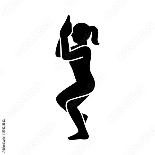Silhouette of woman balancing in eagle yoga pose with arms wrapped
