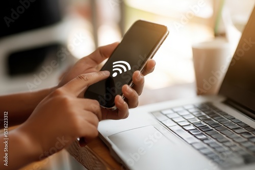 A person is using a cell phone to connect to a wifi network. The phone is being held in their hand and they are pressing a button on the screen. Concept of staying connected to the internet