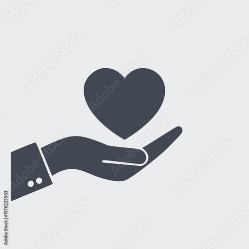 Dark gray heart held in open hand holding giving