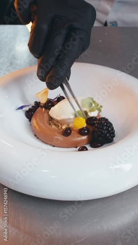 close up step-by-step process of preparing and presenting an exquisite haute cuisine dessert in Michelin-starred restaurant. slow motion video chef lays out ingredients decorations details on plate