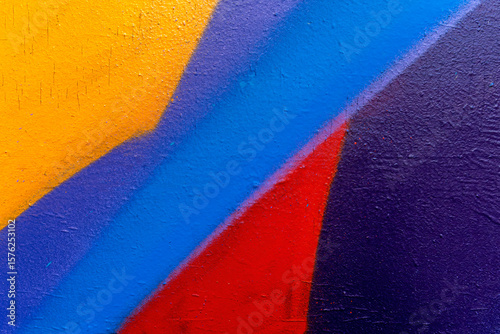 Beautiful colorful street art graffiti background. The wall is decorated with abstract drawings house paint. Modern style urban culture of street youth. Abstract picture on wall