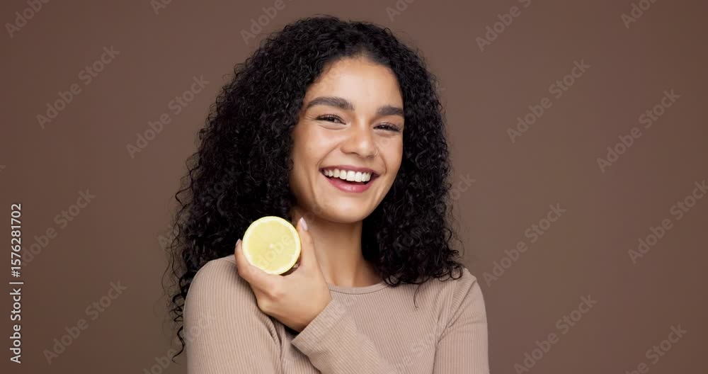 Happy woman, face and lemon with fruit in studio for citrus or detox on a brown background. Portrait, female person or model with smile for natural organic diet, vitamin c or health on space