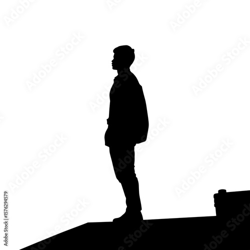Young man standing in silhouette on rooftop against white background  