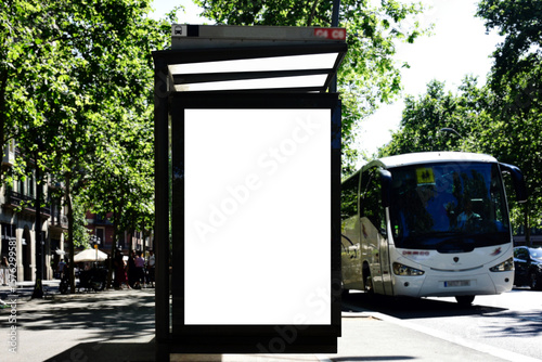 bus shelter with blank ad panel. billboard display. empty white lightbox sign at bus stop. billboard mockup. glass structure. city transit station. urban street traffic setting. outdoor advertising