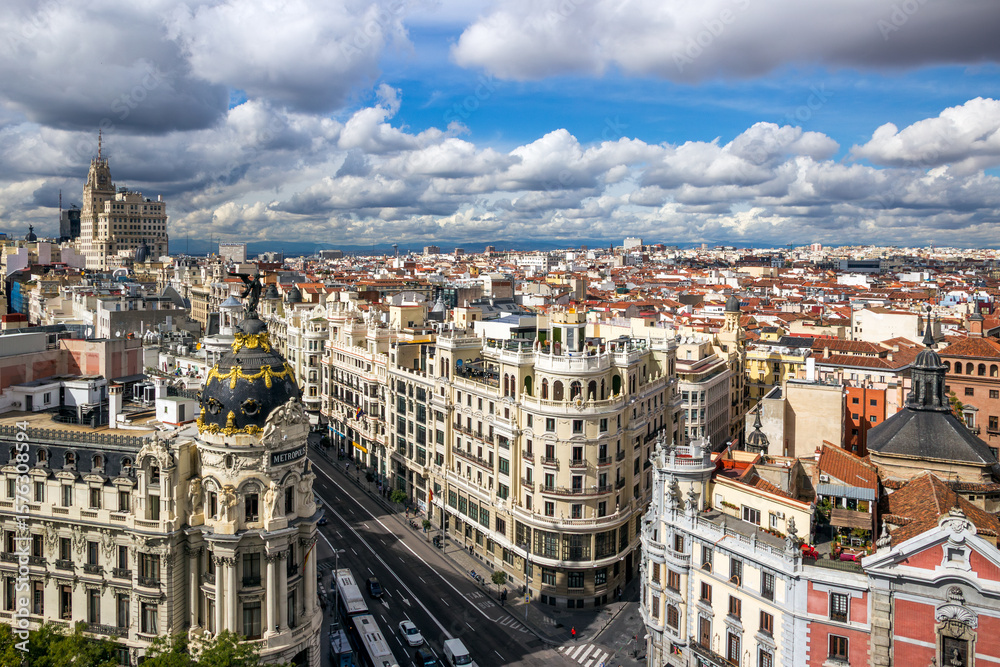 Fototapeta premium View of Gran Vía, Madrid’s famous central avenue known for its shops, theaters, and historic architecture.