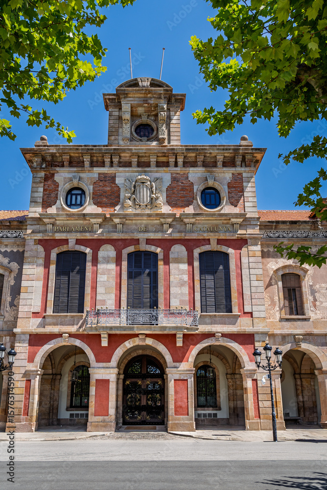 Fototapeta premium Barcelona, Spain-April 21, 2025. Facade of the Parliament of Catalonia in Ciutadella Park, Barcelona, Spain showcasing neoclassical architecture on a bright summer day.