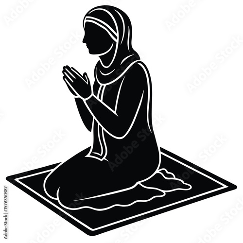 Muslim woman wearing hijab praying on prayer mat silhouette