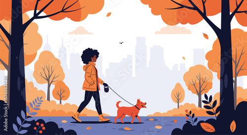 A woman and her dog enjoy a beautiful autumn day walking through a park with city skyline in the background